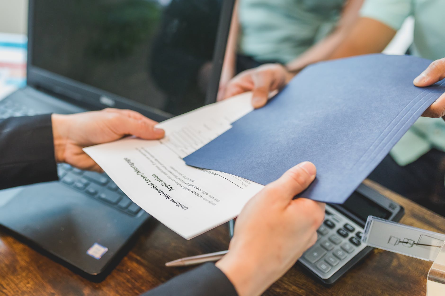 real estate agent giving a printed document to a buyer